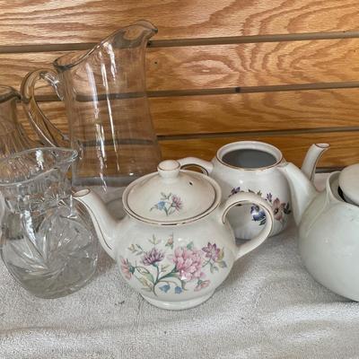Clear glass water pitcher and teapots