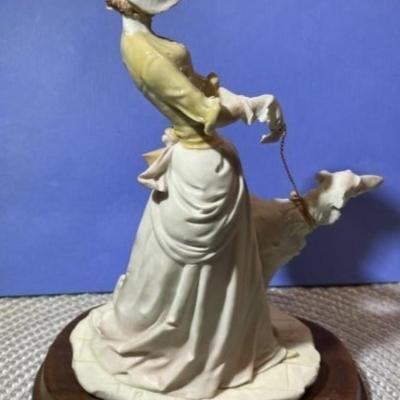 Vintage Arnart Pucci Porcelain Victorian Lady Walking Dog Figurine on Attached Wooden Base in VG Condition.