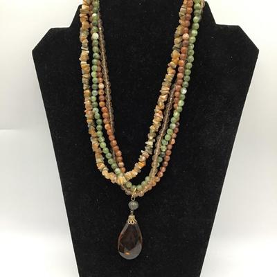 Green and brown beaded necklace with charm