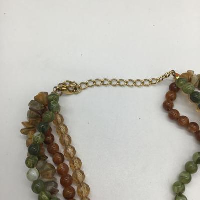 Green and brown beaded necklace with charm