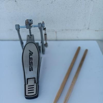 Alesis chain Kick Drum Pedal with a pair of drumsticks