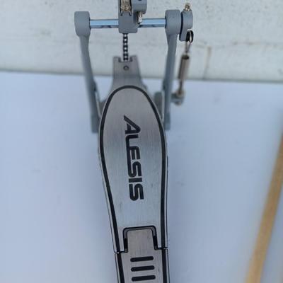 Alesis chain Kick Drum Pedal with a pair of drumsticks