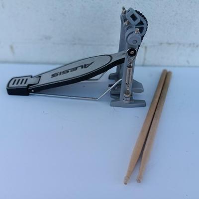 Alesis chain Kick Drum Pedal with a pair of drumsticks