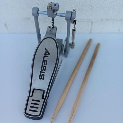 Alesis chain Kick Drum Pedal with a pair of drumsticks