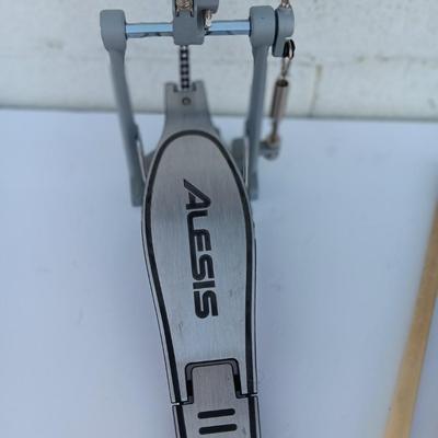 Alesis chain Kick Drum Pedal with a pair of drumsticks