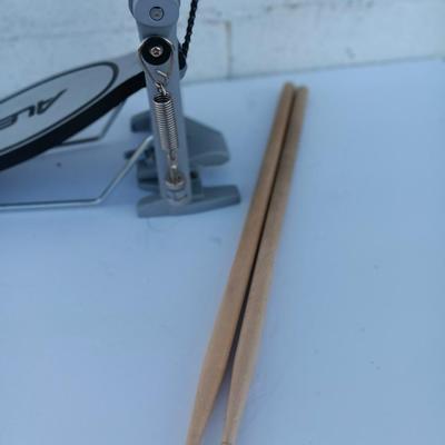 Alesis chain Kick Drum Pedal with a pair of drumsticks