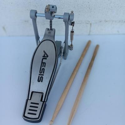 Alesis chain Kick Drum Pedal with a pair of drumsticks