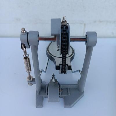 Alesis chain Kick Drum Pedal with a pair of drumsticks