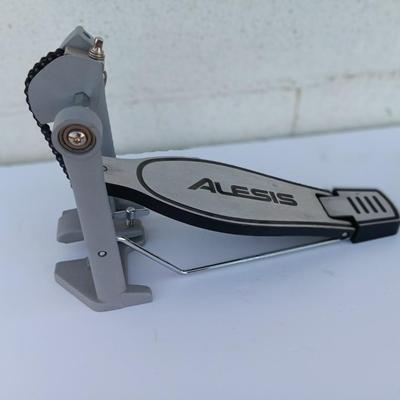Alesis chain Kick Drum Pedal with a pair of drumsticks