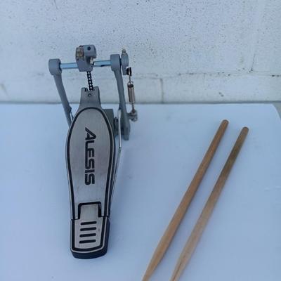 Alesis chain Kick Drum Pedal with a pair of drumsticks