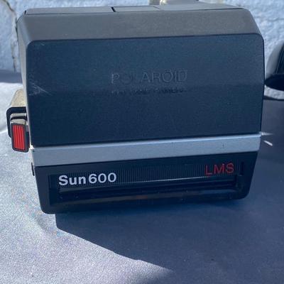 A Fun Polaroid sun600 Camera, with a EOS Canon Rebel E2 Camera