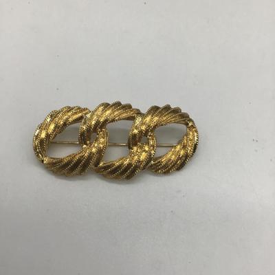 Gold toned design pin