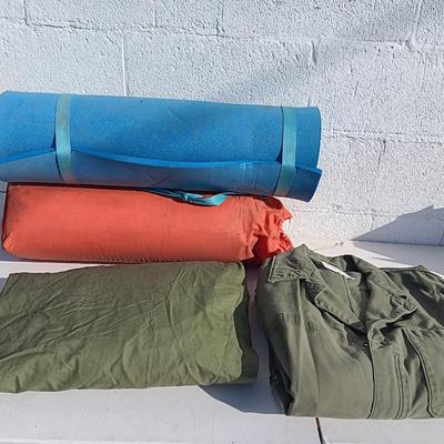 Military issued sleeping bag. - bed cushions - coveralls - and a waterproof military bag cover