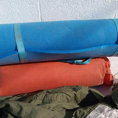 Military issued sleeping bag. - bed cushions - coveralls - and a waterproof military bag cover