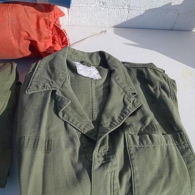 Military issued sleeping bag. - bed cushions - coveralls - and a waterproof military bag cover