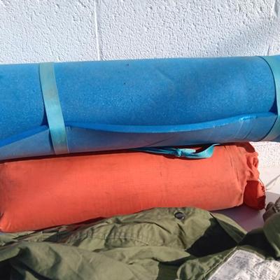 Military issued sleeping bag. - bed cushions - coveralls - and a waterproof military bag cover