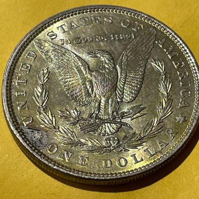 1886-P NICELY TONED REVERSE UNCIRCULATED MORGAN SILVER DOLLAR AS PICTURED.