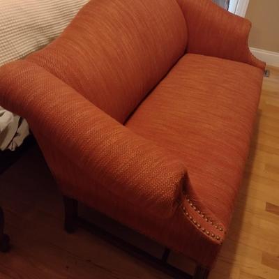 Camel Back Upholstered Loveseat with Brass Tack Accents