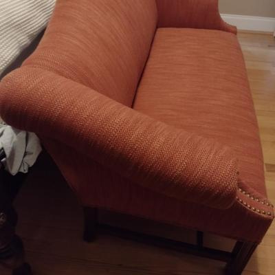 Camel Back Upholstered Loveseat with Brass Tack Accents