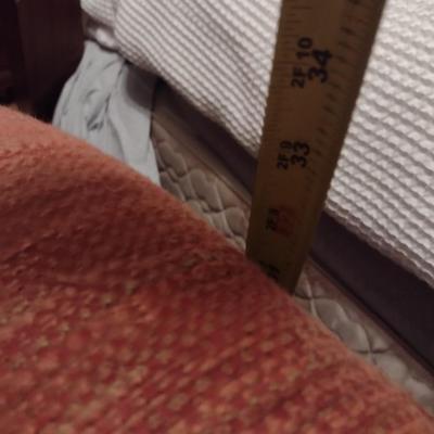 Camel Back Upholstered Loveseat with Brass Tack Accents