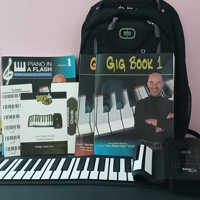 LOT 248: Collection of Scott Houston Piano Books, Mukikim Roll-Up Piano & 'How To Get Away With Murder' Promotional Backpack
