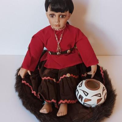 Porcelain Native American doll with small clay pot