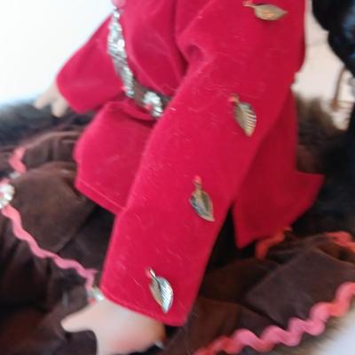 Porcelain Native American doll with small clay pot