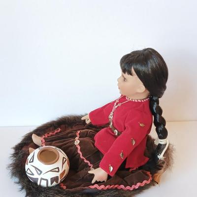 Porcelain Native American doll with small clay pot