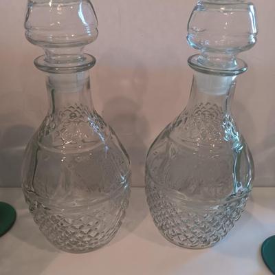 Two matching Princess House decanters with six green stemmed glasses