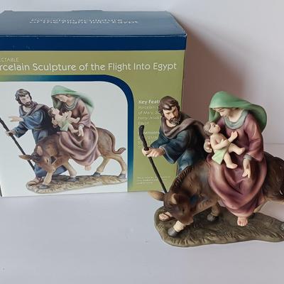 Porcelain sculpture of the flight to Egypt with wood wall handing Jesus and 