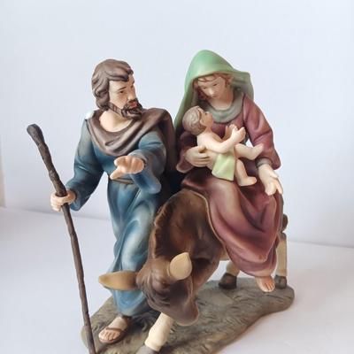 Porcelain sculpture of the flight to Egypt with wood wall handing Jesus and 