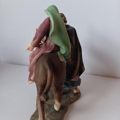 Porcelain sculpture of the flight to Egypt with wood wall handing Jesus and 