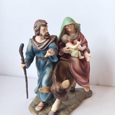 Porcelain sculpture of the flight to Egypt with wood wall handing Jesus and 