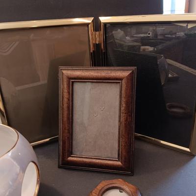 A variety of picture frames with a beautiful, signed porcelain blue rose votive.