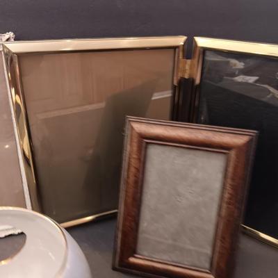 A variety of picture frames with a beautiful, signed porcelain blue rose votive.