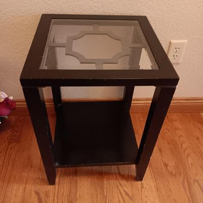 Black framed - glass topped end table with a beautiful bouquet of faux Roses.