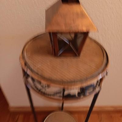 Two-tiered Metal and wicker plant stand with small metal votive lantern