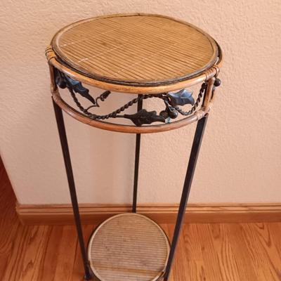 Two-tiered Metal and wicker plant stand with small metal votive lantern