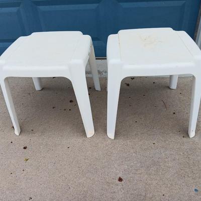 Two white plastic patio end tables