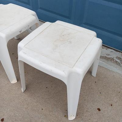 Two white plastic patio end tables