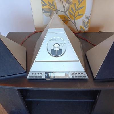Cool Radio Shack light up am/FM CD / Cassette Clock radio with speakers on a Black media cabinet stand.