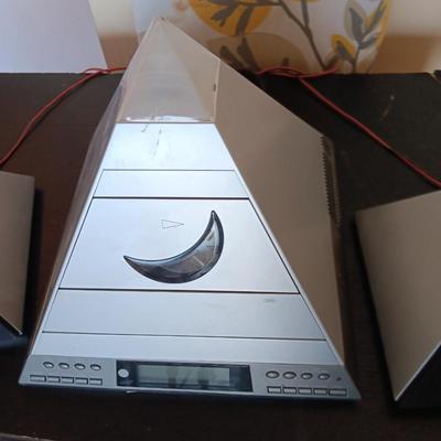Cool Radio Shack light up am/FM CD / Cassette Clock radio with speakers on a Black media cabinet stand.