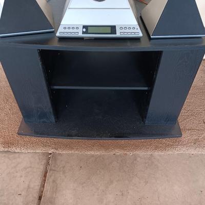 Cool Radio Shack light up am/FM CD / Cassette Clock radio with speakers on a Black media cabinet stand.