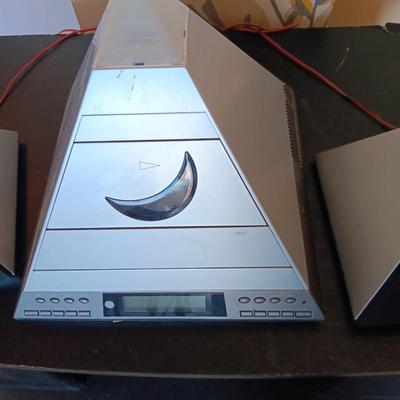 Cool Radio Shack light up am/FM CD / Cassette Clock radio with speakers on a Black media cabinet stand.