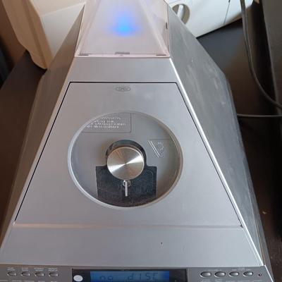 Cool Radio Shack light up am/FM CD / Cassette Clock radio with speakers on a Black media cabinet stand.