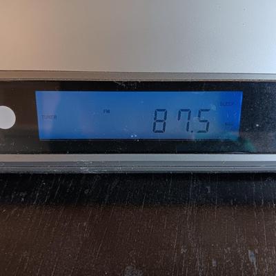 Cool Radio Shack light up am/FM CD / Cassette Clock radio with speakers on a Black media cabinet stand.