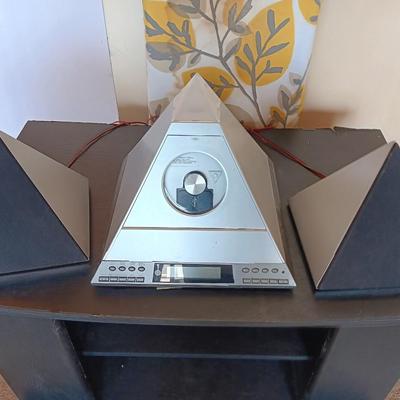 Cool Radio Shack light up am/FM CD / Cassette Clock radio with speakers on a Black media cabinet stand.