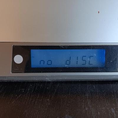 Cool Radio Shack light up am/FM CD / Cassette Clock radio with speakers on a Black media cabinet stand.