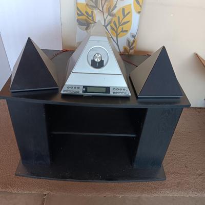 Cool Radio Shack light up am/FM CD / Cassette Clock radio with speakers on a Black media cabinet stand.