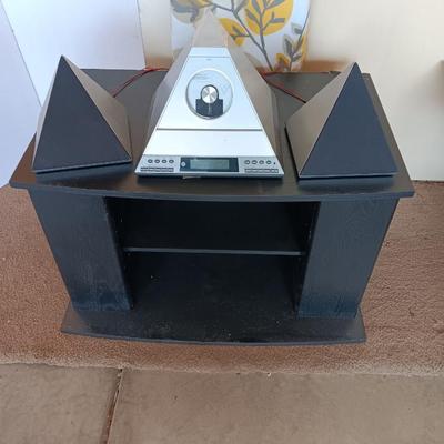 Cool Radio Shack light up am/FM CD / Cassette Clock radio with speakers on a Black media cabinet stand.